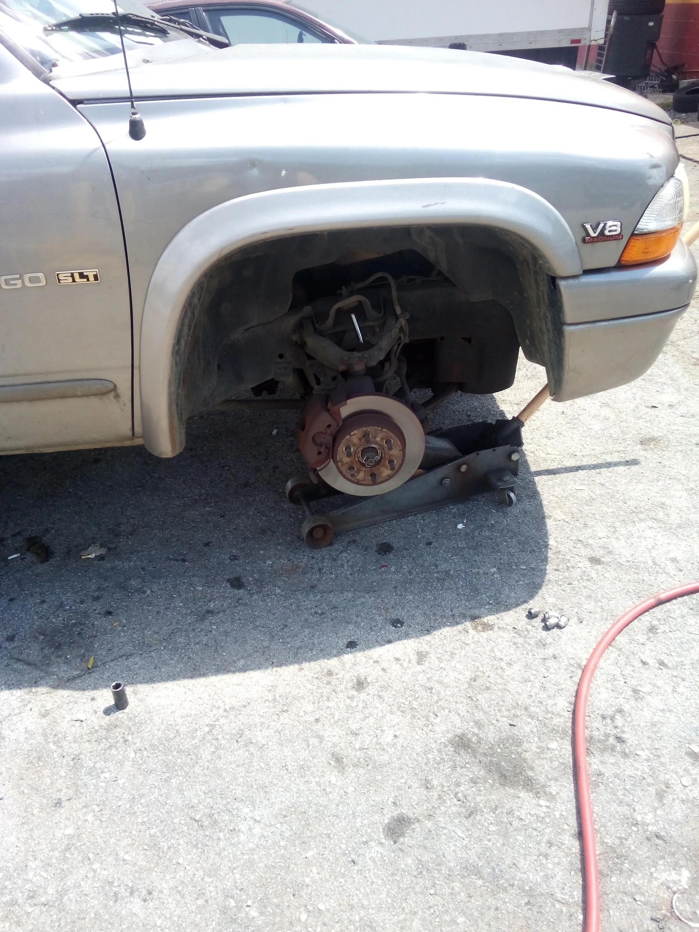 A truck's front brake rotor exposed for service